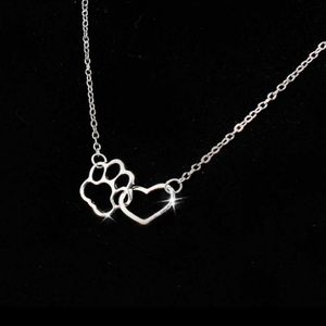 Heart & paw print silver color necklace.